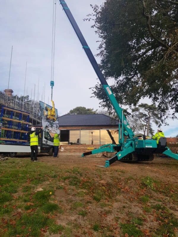 crane lifting the glazing for aluminium door