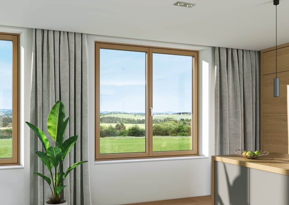 Lower-Carbon Glass Windows and Doors 2 a room with large glass windows and a clear view over the Wiltshire countryside.