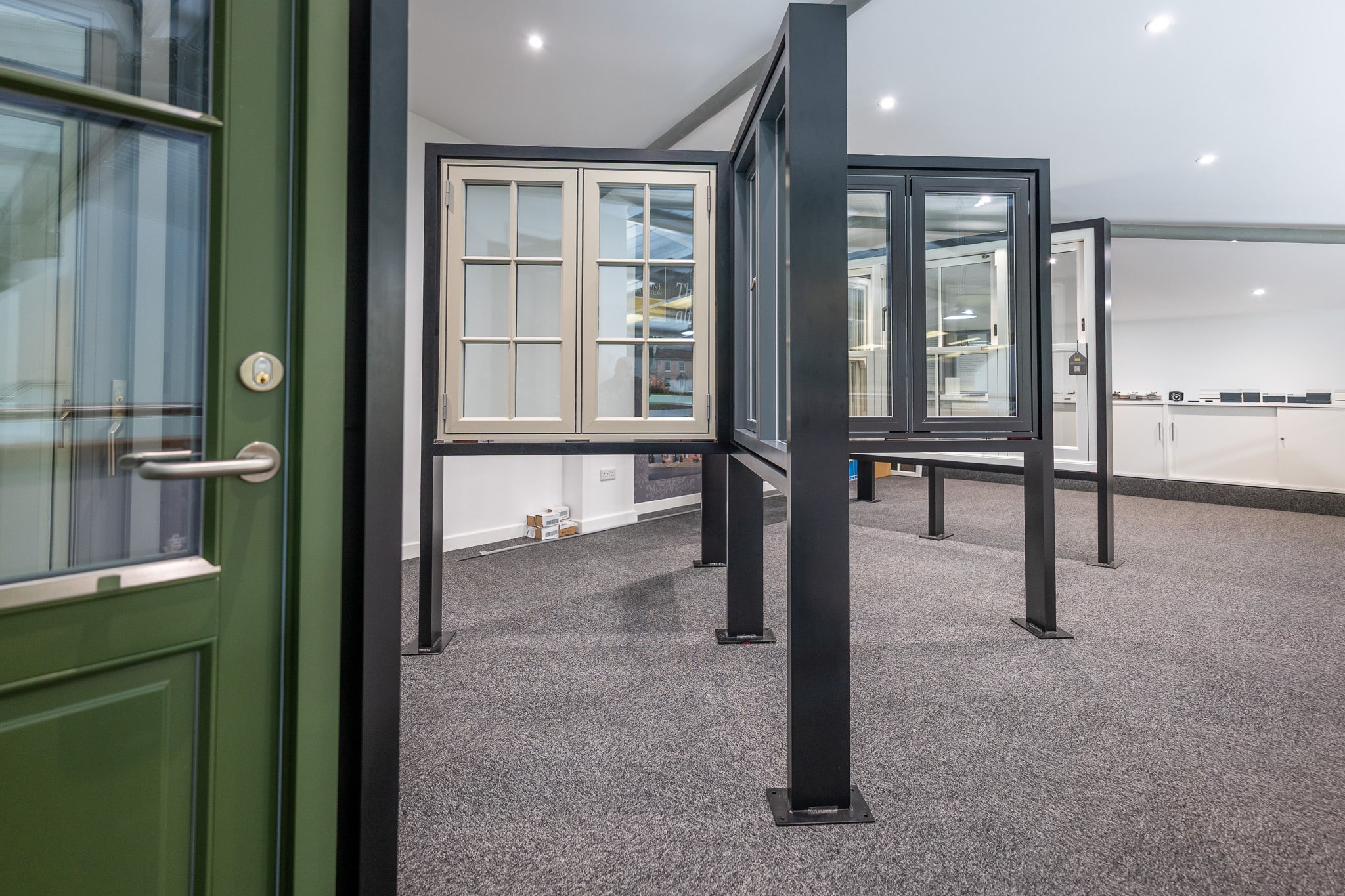 Rationel Windows and doors in the CBP showroom shoing windows in a stand and green door