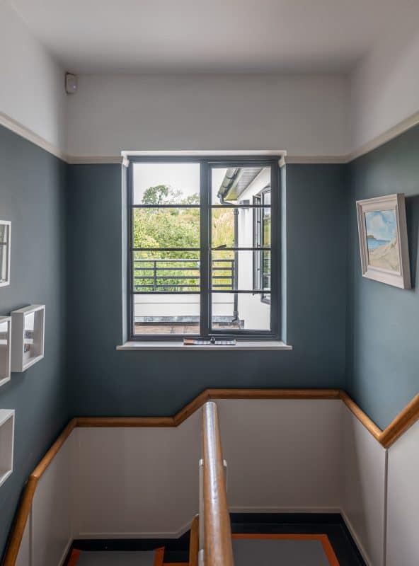 Period landing in an art deco house with aluco black window