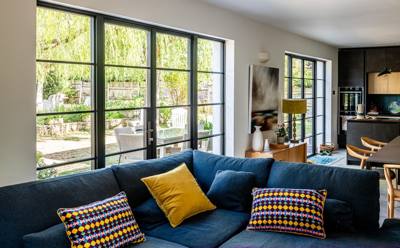 French doors with side panels behind blue sofa