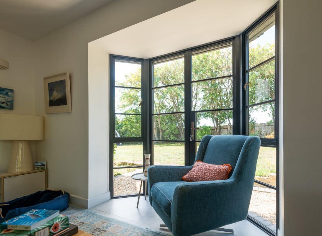 internal view of Aluco french doors with blue chair in a bay design