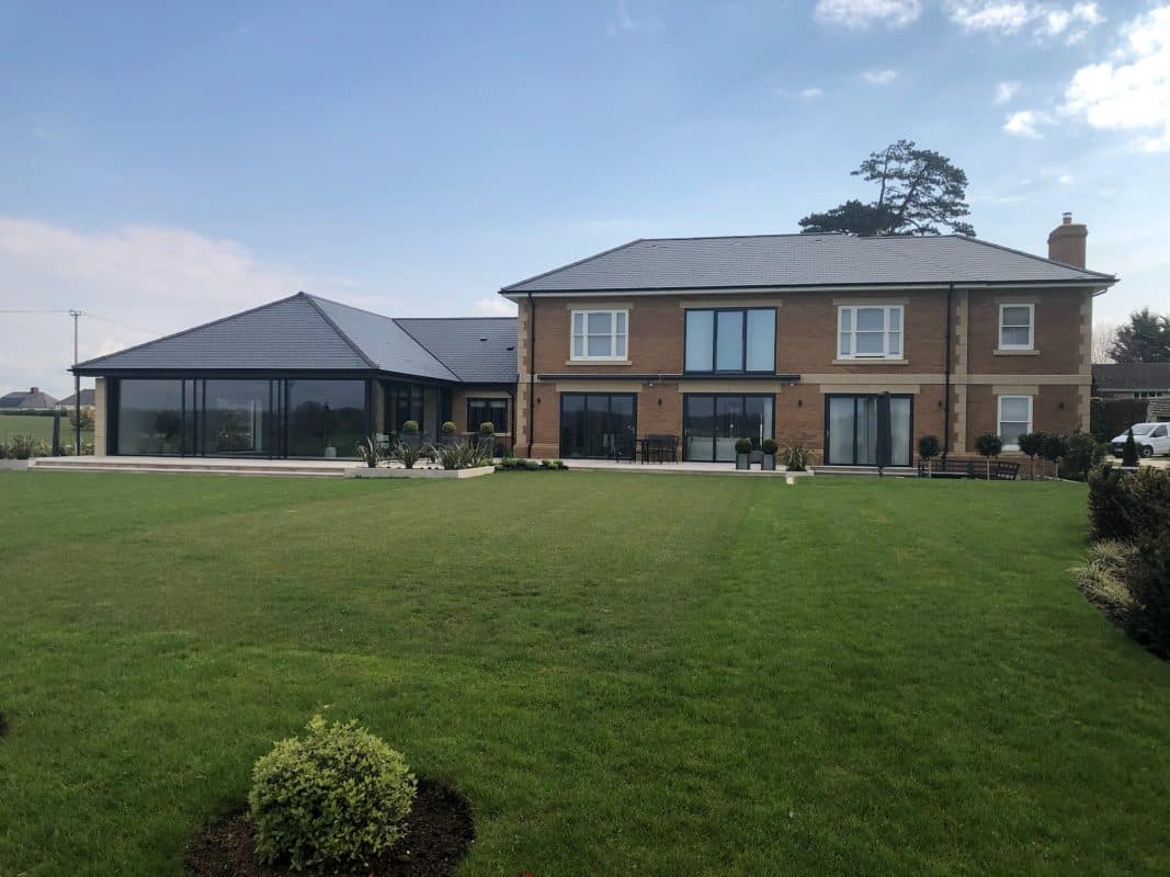 outside view of house wit pool extension and bifold doors. 