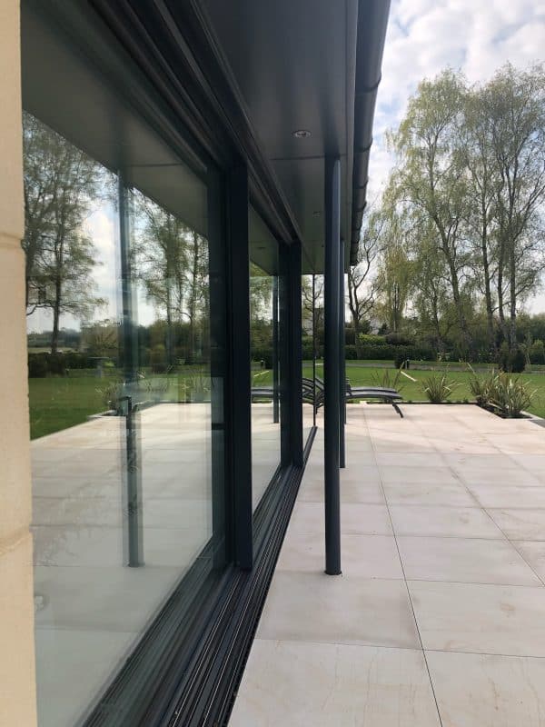 close up of Solarlux cero III sliding doors in a pool extension