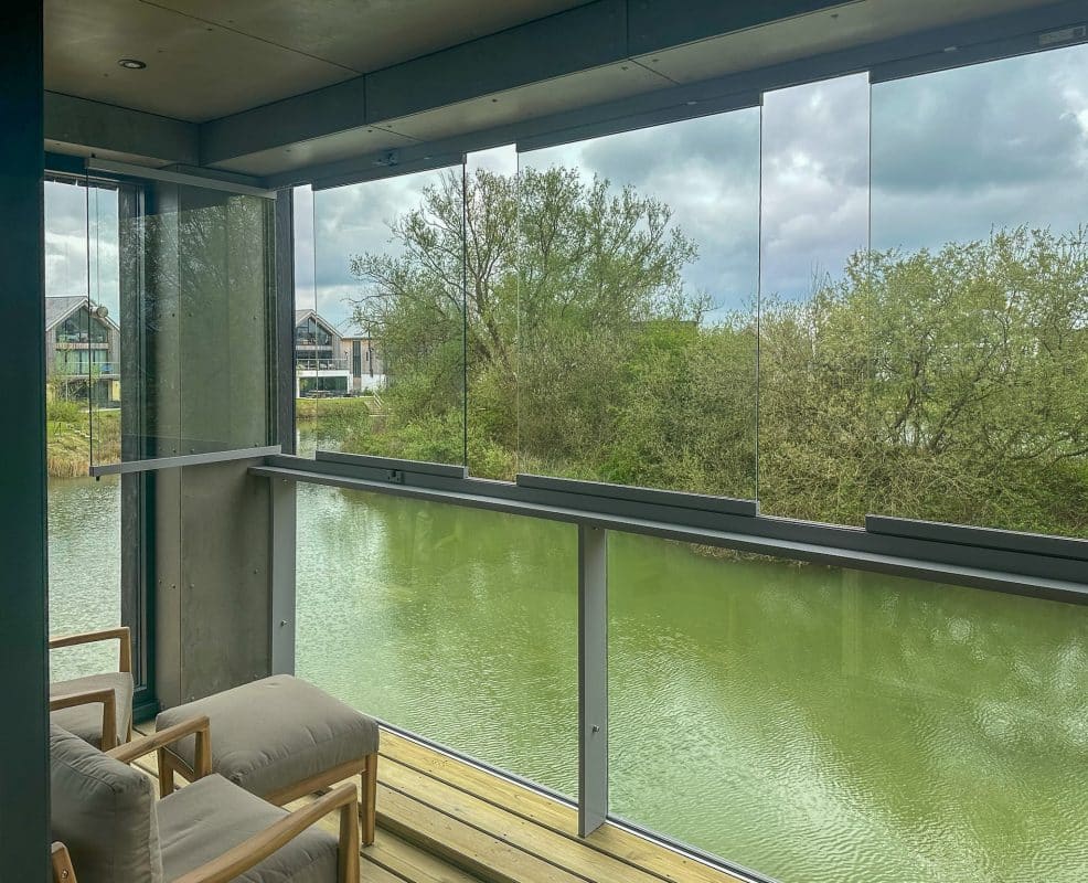 Picture of open sliding door with decked balcony area and glass balustrades with balcony enclosure