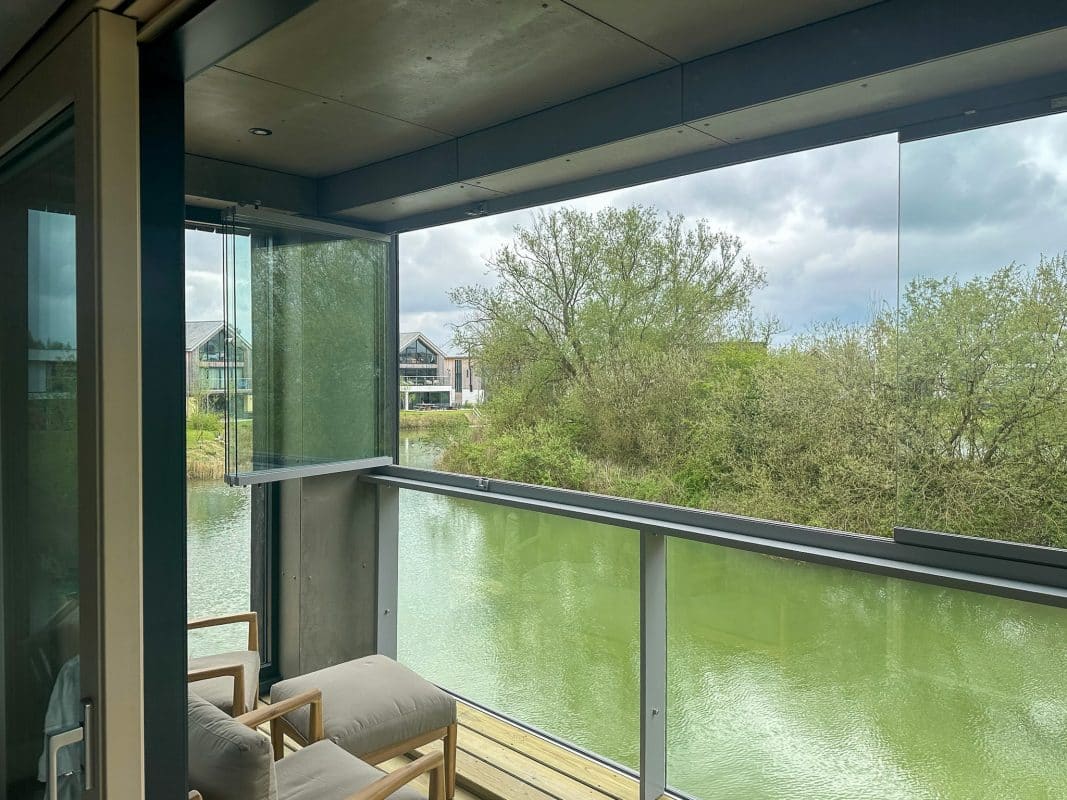 Picture of open sliding door with decked balcony area and glass balustrades with balcony enclosure