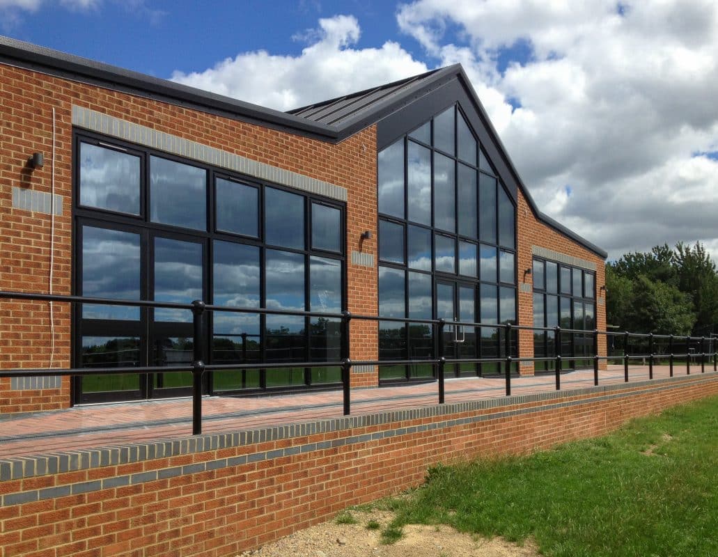 Large black glazed screen for Wooton Basset Rubgy Club with gable centre and two large side returns