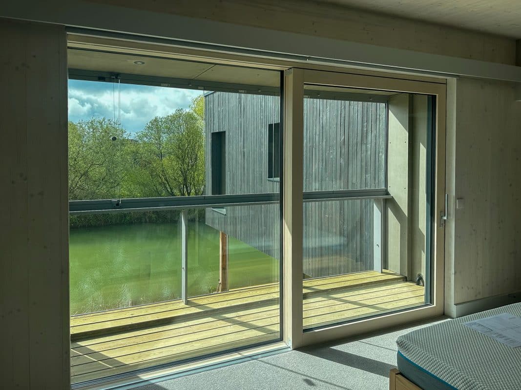 Picture of open sliding door with decked balcony area and glass balustrades with balcony enclosure