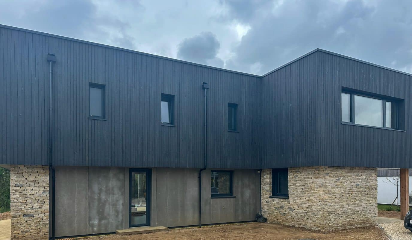 internorm windows fitted to a stone and cedar clad contemporary home. 