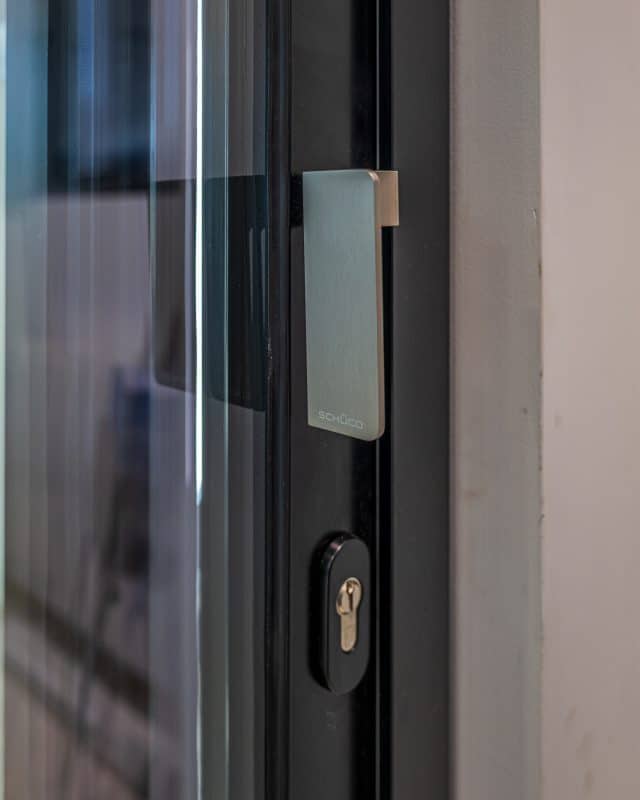 Contemporary Chalet Home in Somerset with Schüco Patio Doors 3 Schüco ASE 51 PD handle closed position