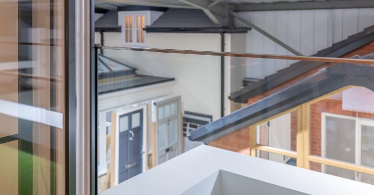 Glass Balustrades and Juliet Balconies. What Homeowners Need to Know 2 Glass balustrade integrated with internorm doors in a double glazing showroom