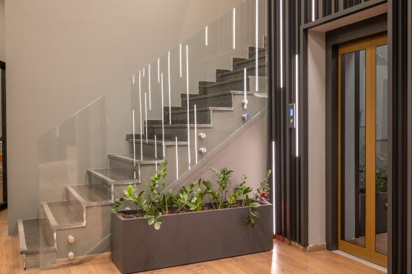 Glass Balustrades and Juliet Balconies. What Homeowners Need to Know 3 Glass balustrade and staircase next to a lift